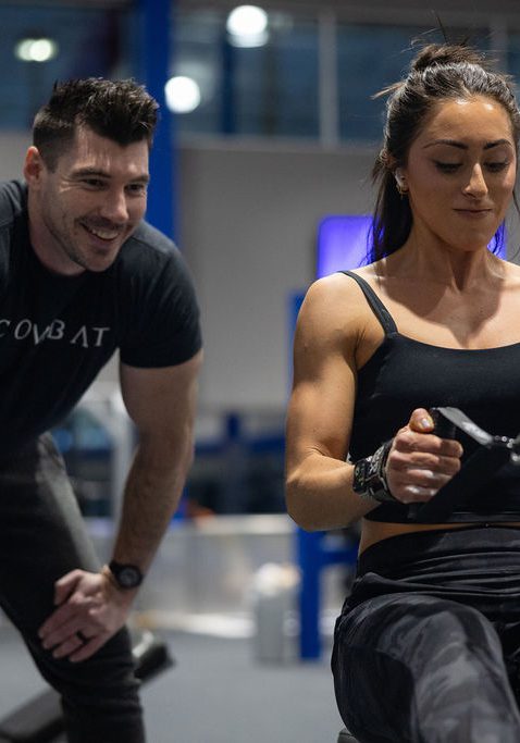 Personal trainer coaching woman during workout at The Workout Club Londonderry gym