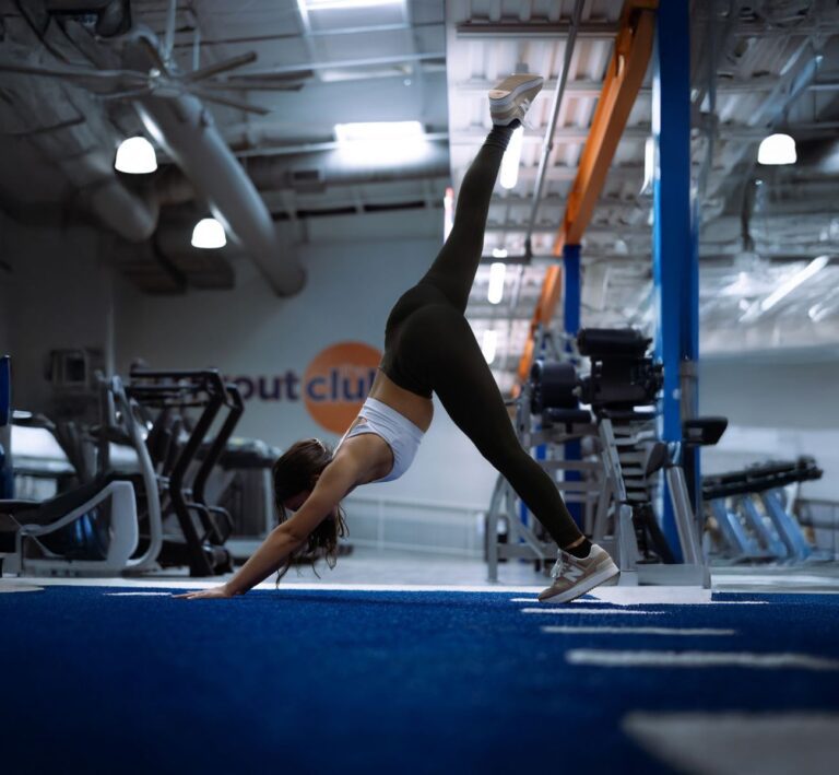 the-workout-club-salem-nh-location-near-me-fitness-membership-flexibility-training-woman-pose-yoga-zen-calm-downward-dog-split-fitness-training-class