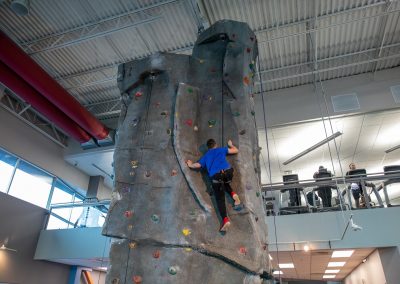 Climbing on the Indoor Rock Wall at Workout Club in Salem