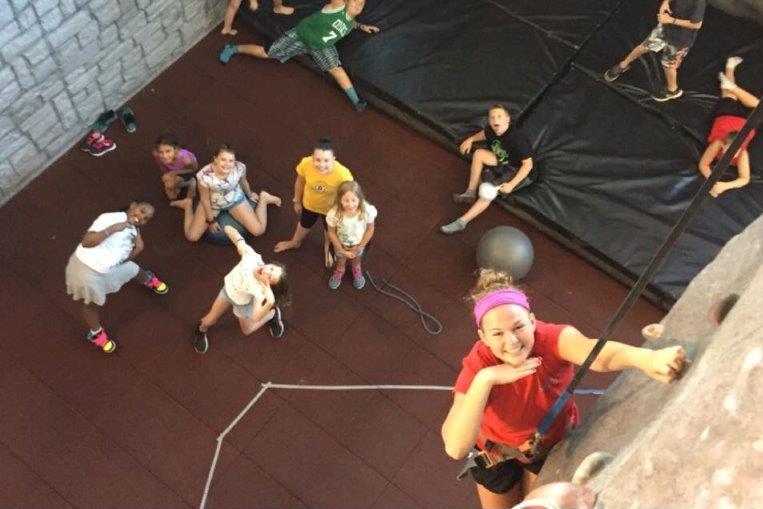 Children in summer camp climbing rockwall at the Salem gym. 
