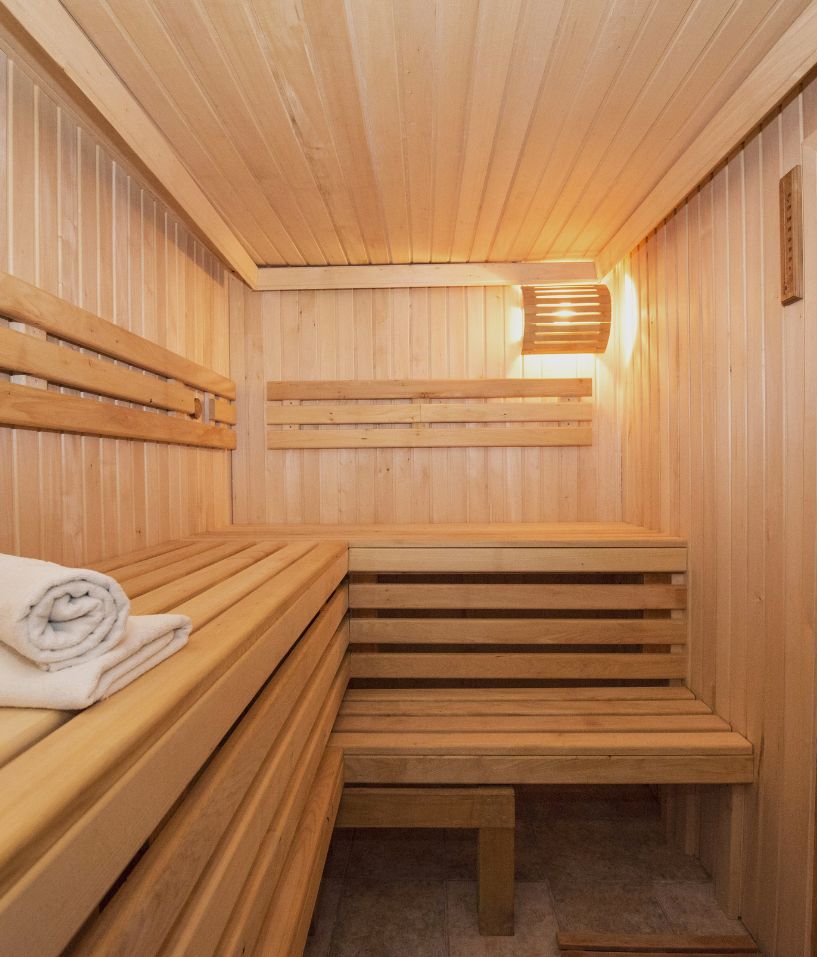 Modern sauna room showcasing one of The Workout Club’s luxury wellness amenities available at select locations.