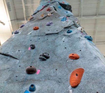 Indoor rock climbing wall at The Workout Club Salem NH, perfect for kids and adults looking for a fun and challenging fitness activity in a local gym.